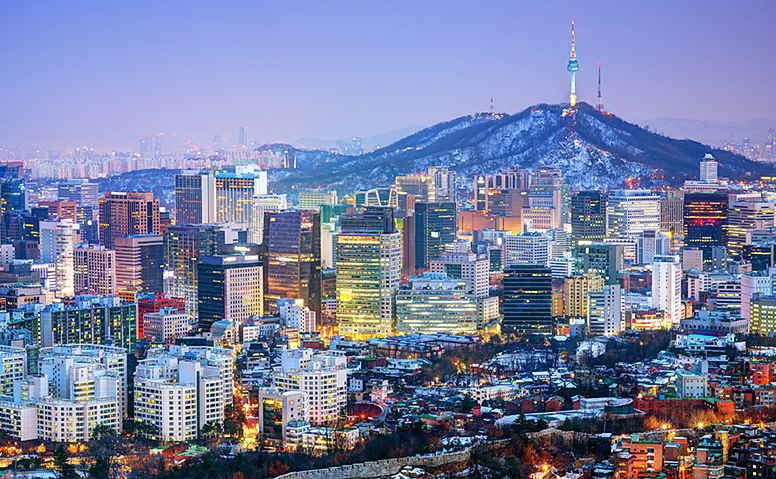 South Korea: Night shot of Seoul with brightly lit skyscrapers. Mount Namsan can be seen in the background