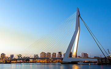 Netherlands: Rotterdam skyline at dusk, the Erasmus Bridge can be seen in the foreground