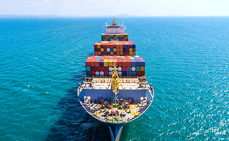 Sea freight: Large ship at sea loaded with many colourful containers Sea freight: Large ship at sea loaded with many colourful containers