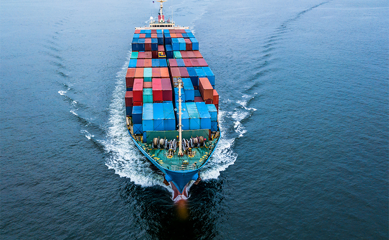 Large ship at sea loaded with many colourful containers